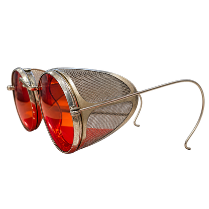 Angled view of vintage round red-lens eyeglasses with metal mesh side shields and cable temples